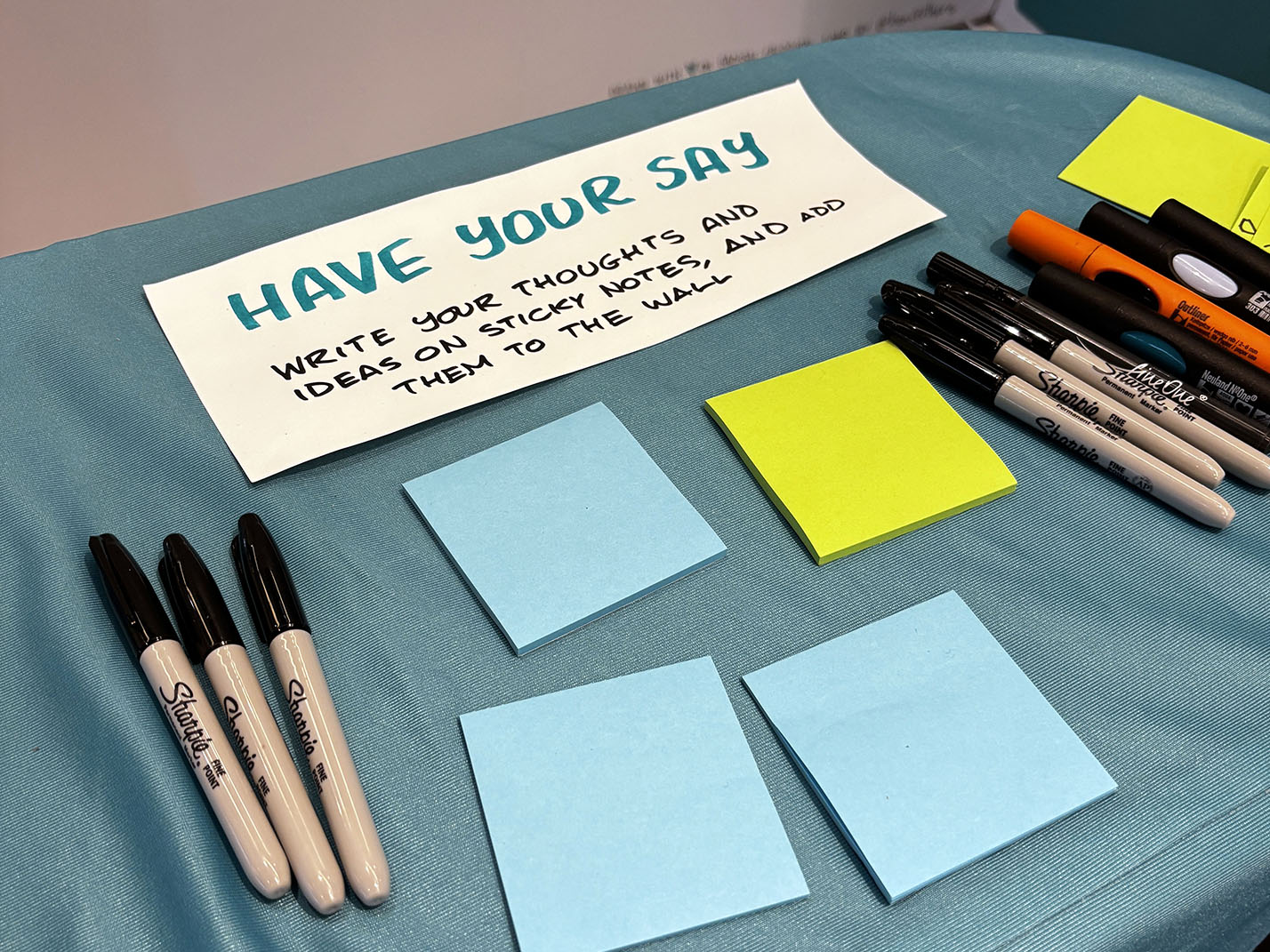 Photo of the table with sticky notes and markers for nurses to write their thoughts and ideas