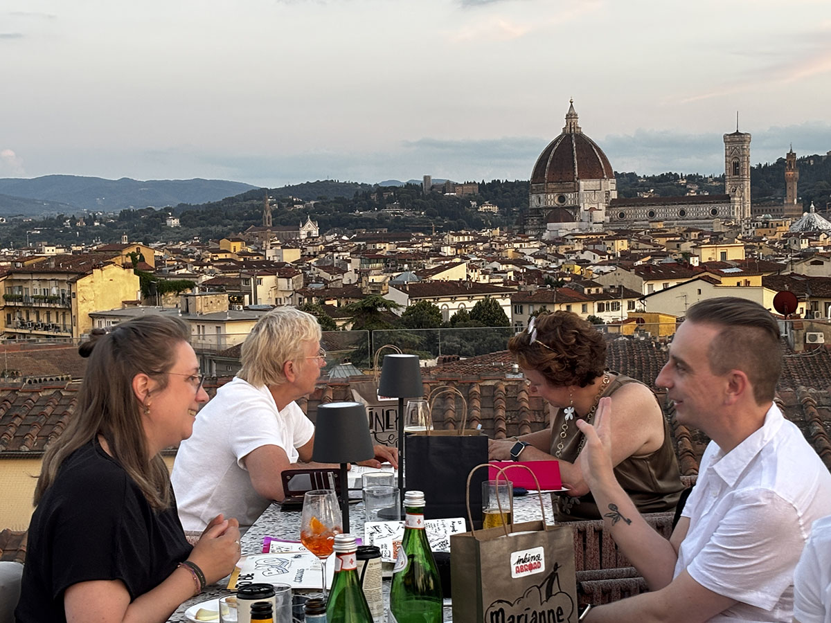 A photo of some of our group dining and chatting on the rooftop bar of the hotel, overlooking the Florence cityline
