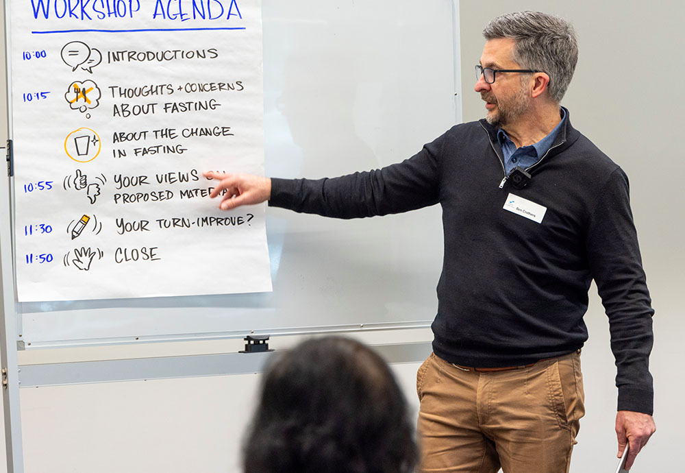 Photo of Ben Crothers going through an agenda at a workshop