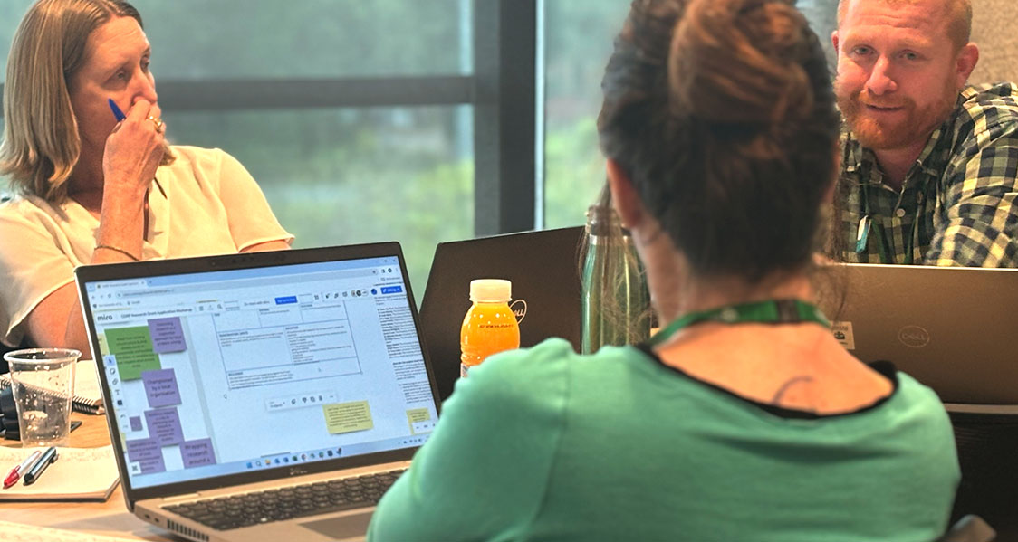 A photo of some participants during a hybrid workshop, using an online collaboration board on Miro